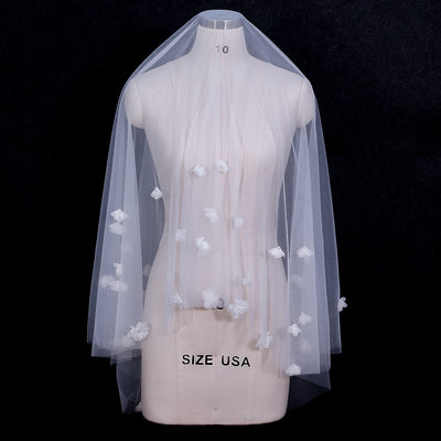 White and ivory sheer fabric swatches for a wedding veil displayed on green grass. - Image 10