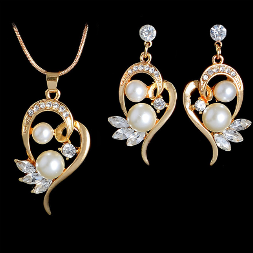 Gold-toned heart-shaped necklace and dangle earrings set with clear rhinestones and faux pearls. - Image 12