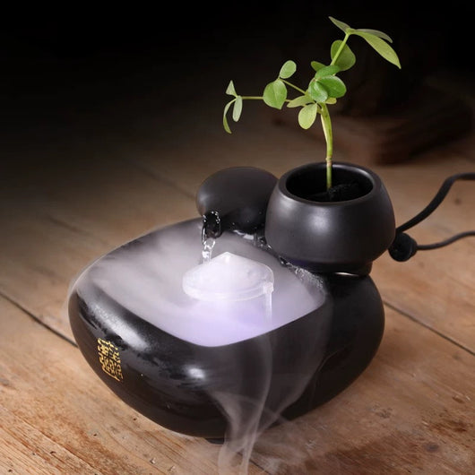 White ceramic flowing water fountain ornament with an integrated planter holding a green plant. Features gold Chinese characters. - Image 5