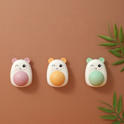White and pink cartoon bear catnip toy with a winking face and a pink spinning ball on its belly. - Image 2