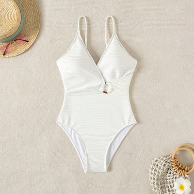 White textured one-piece swimsuit with deep V-neck and wooden O-ring detail, styled with a light-wash denim jacket. - Image 5