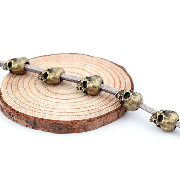 Red velvet rope with six silver-colored skull beads, ideal for DIY hair accessories or crafting projects.