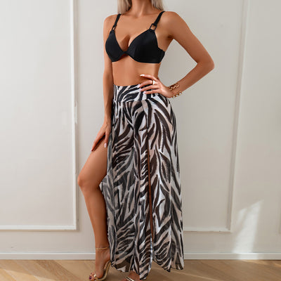 Women's pink, black, and white abstract striped bikini with a push-up top and strappy high-cut bottoms on a beach. - Image 16