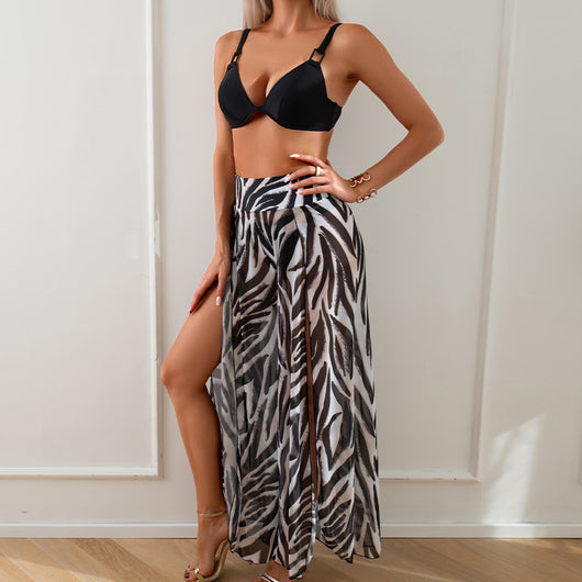 Women's pink, black, and white abstract striped bikini with a push-up top and strappy high-cut bottoms on a beach. - Image 16
