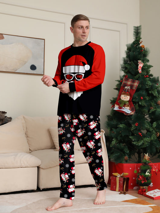 Woman wearing a black and red Christmas pajama set with a Santa Claus graphic top and snowman-patterned pants. - Image 7