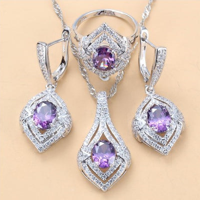 Silver-toned three-piece jewelry set with clear oval and round gems, including a necklace, dangle earrings, and a ring. - Image 11