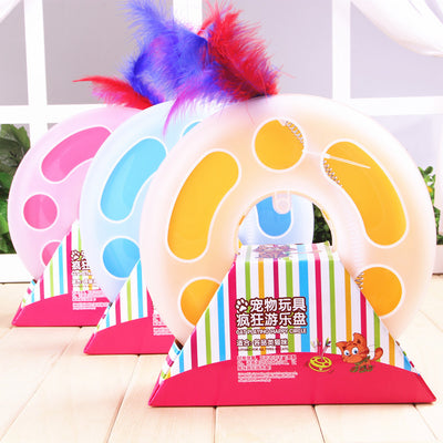 Interactive cat toy with a yellow and white circular ball track base and a spring-mounted feather wand.