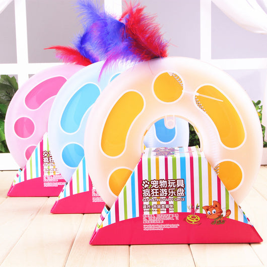 Interactive cat toy with a yellow and white circular ball track base and a spring-mounted feather wand.