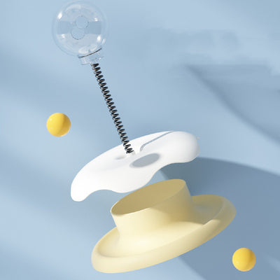Mint green and dark green cat leakage food toy with a clear spherical treat dispenser on a black spring. - Image 6
