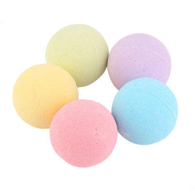 A single, round, light green bath bomb with a slightly textured surface, ready for a relaxing bath.
