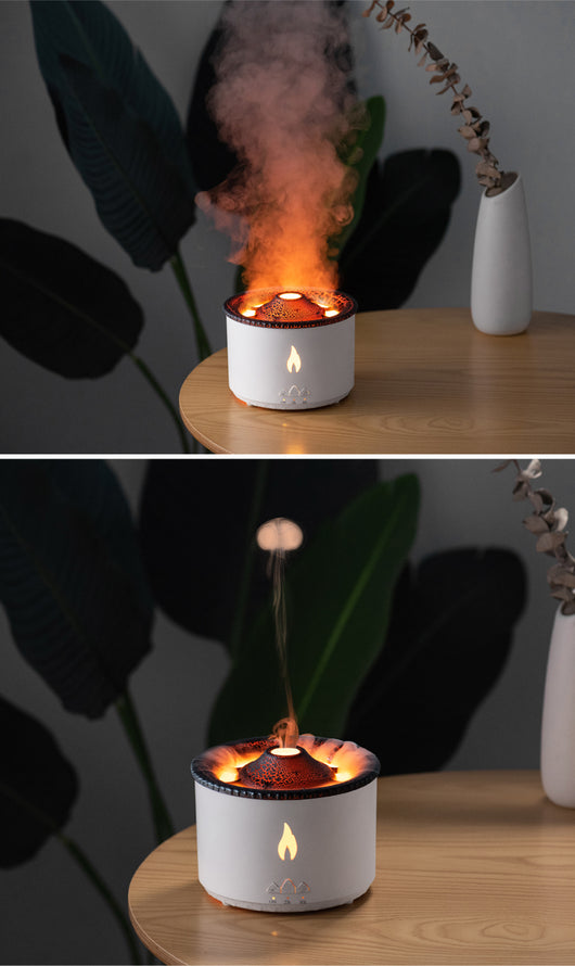 White ultrasonic essential oil diffuser with orange flame effect mist, alongside a gift set of Lavender, Peppermint, Tea Tree, and Sweet Orange essential oils. - Image 21