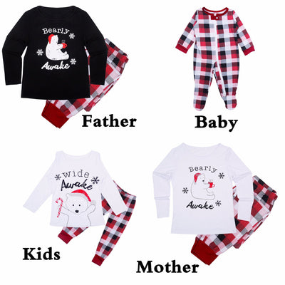 Mother and child in matching red, black, and white plaid Christmas pajamas, child wearing a Santa hat. - Image 9