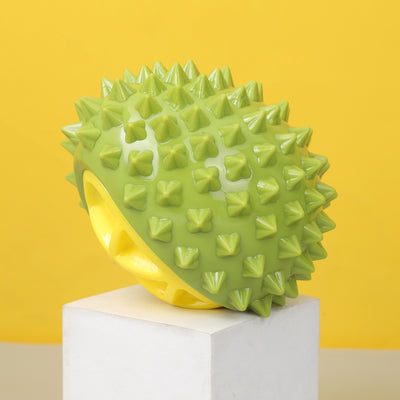 Pink and yellow durian-shaped chew toy with soft spikes, designed for pets, on a white display block. - Image 7