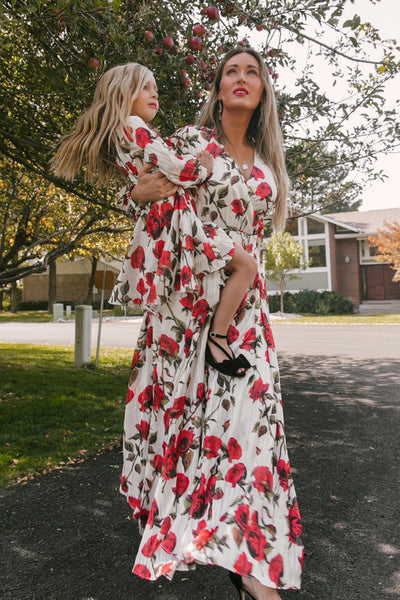 Mother and daughter in matching white dresses with red floral print, V-neck, long sleeves, and tie-waist. - Image 9
