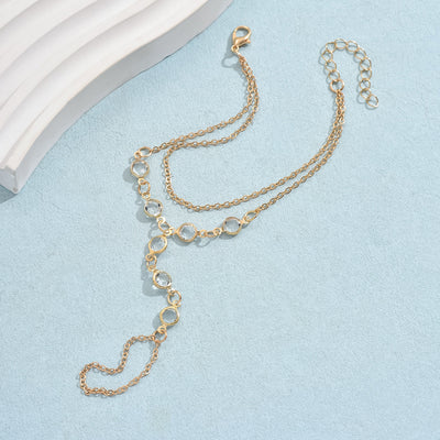 Gold-tone layered bracelet ring with clear crystal accents and a finger loop, featuring a lobster clasp closure. - Image 3