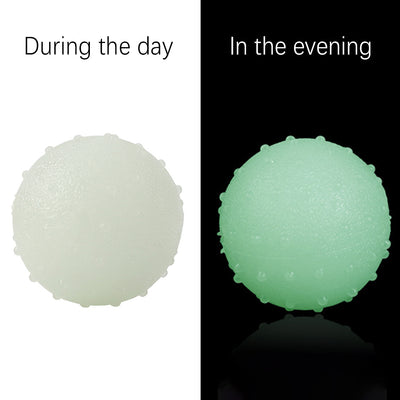 Interactive pet glow ball, off-white in daylight and glowing green in the evening, with a textured surface. - Image 14