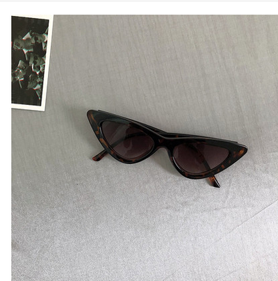 Retro cat-eye sunglasses with a tortoiseshell frame and dark lenses, ideal for a stylish, vintage look. - Image 22