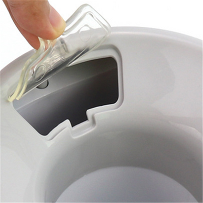 White and grey automatic tennis ball launcher for dogs, dispensing food, with a tennis ball and kibble bowl. - Image 5