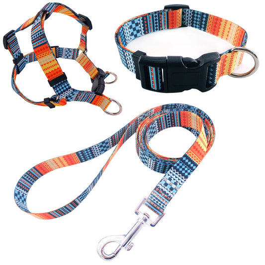 Blue geometric pattern pet collar, harness, and leash three-piece set with black buckles and silver hardware.