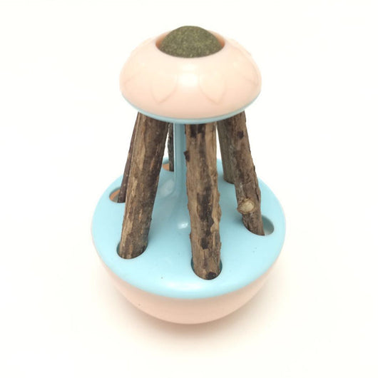 Pink tumbler cat toy with a green catnip ball on top and several natural wooden sticks for chewing. - Image 2