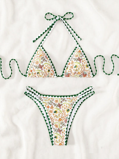 White halter bikini with green rickrack trim and a vibrant floral and bird print, featuring a triangle top and high-cut bottom. - Image 8