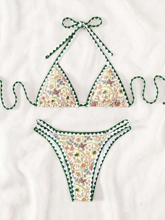 White halter bikini with green rickrack trim and a vibrant floral and bird print, featuring a triangle top and high-cut bottom. - Image 8