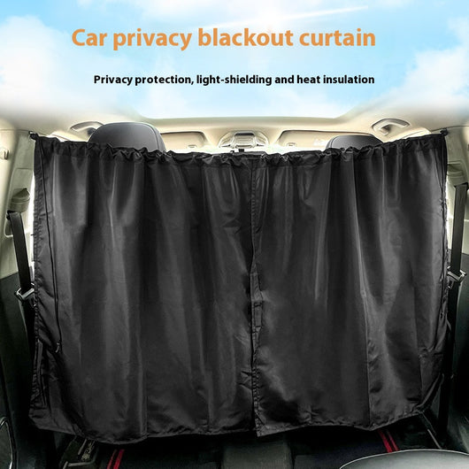 Black Chunya spinning car privacy partition curtain installed between front and rear seats for sun protection.
