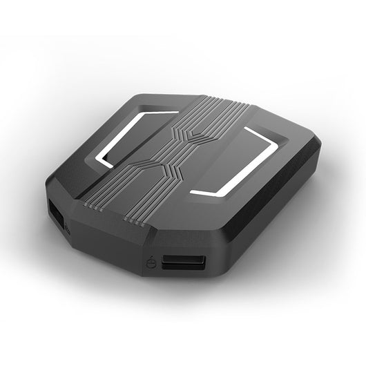 Black keyboard and mouse adapter for gaming consoles with yellow LED accents, next to its product box. - Image 6