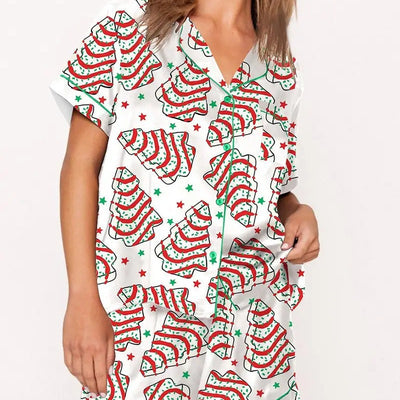 White short-sleeve pajama set with red and green Christmas tree and star print, featuring green piping. - Image 3