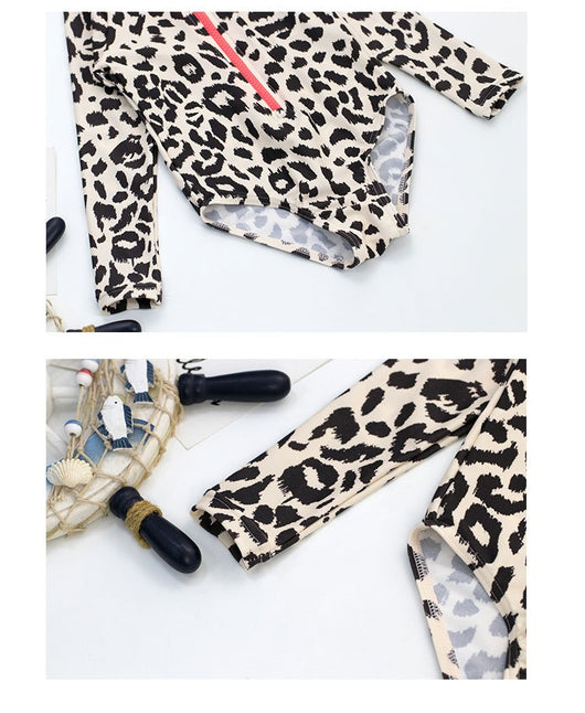 Child's long-sleeve leopard print swimsuit with a coral zipper and a matching swim cap on a white background. - Image 14