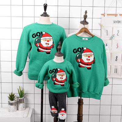 Red parent-child Christmas sweaters with a cartoon Santa Claus graphic, displayed on adult and child mannequins.