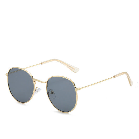 Round gold-framed sunglasses with pink tinted lenses, featuring clear temple tips. - Image 27
