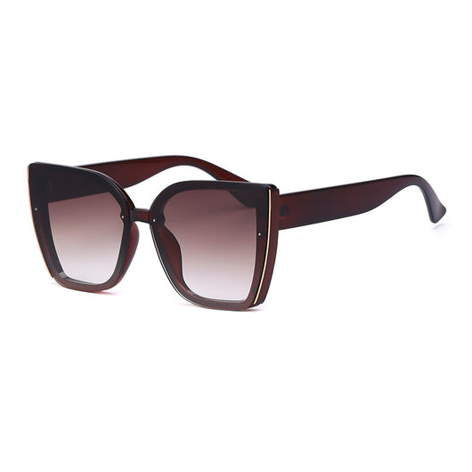 Women's black cat-eye sunglasses with large frames, gradient gray lenses, and gold-tone accents. - Image 3
