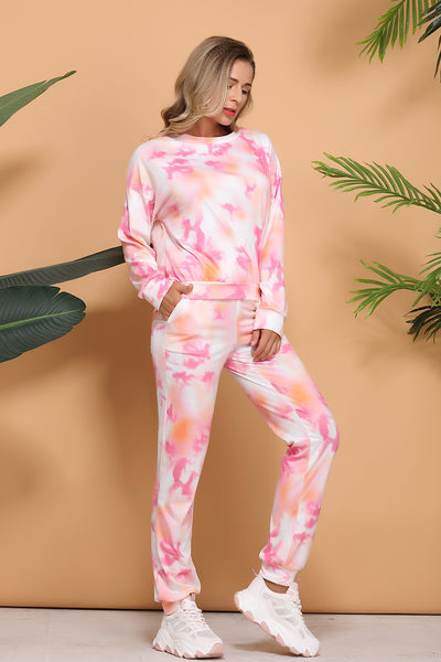 Woman wearing a pink and white tie-dye long-sleeve top and matching pants set, posing casually. - Image 11