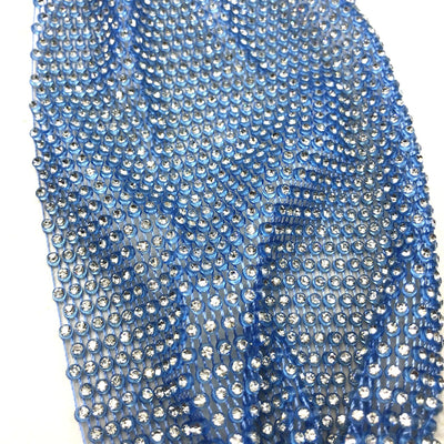 Close-up of a blue mesh fabric adorned with numerous small, clear rhinestones, creating a sparkling texture. - Image 12