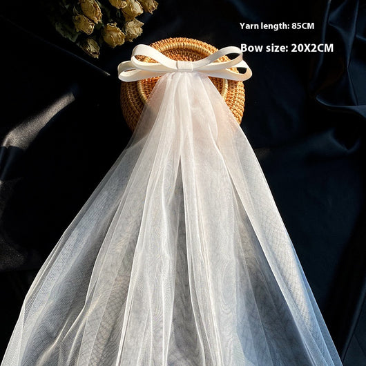 White birdcage veil with a cream satin bow and faux pearls, attached to a woven straw base, 80cm yarn length. - Image 12