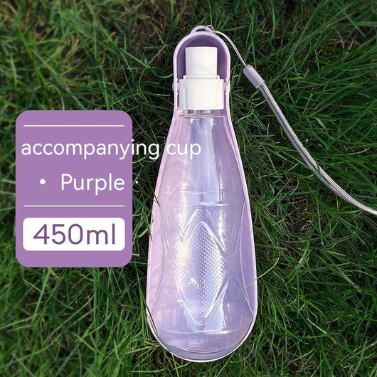 Yellow 450ml portable pet water bottle with a folding drinking trough and white wrist strap, on grass. - Image 9