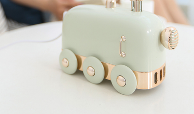 Pink retro mini train ultrasonic humidifier and aroma diffuser with rose gold accents on a white background. - Image 6