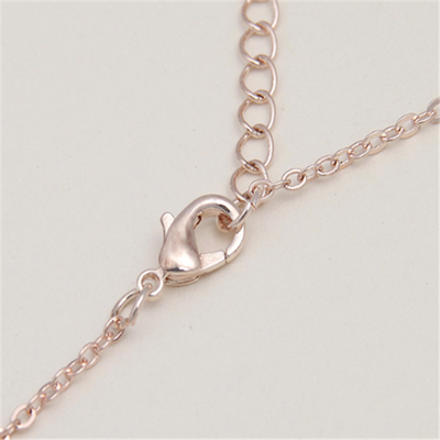 Rose gold-toned necklace and stud earrings set with faux pearls and clear rhinestones, displayed on a white background. - Image 3