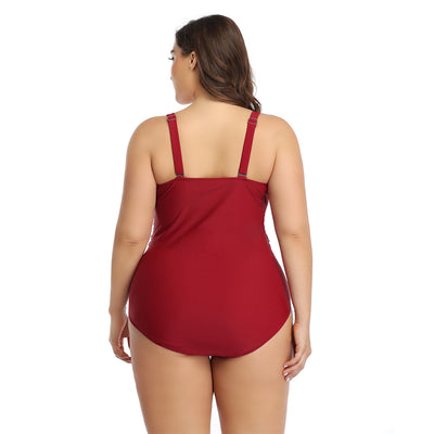 Plus size one-piece swimsuit with a red tropical leaf print top and solid dark red bottom, featuring a crossover chest. - Image 4