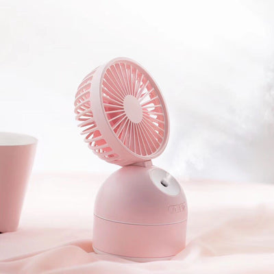 Dark grey fan humidifier with a round fan head and spherical base, emitting mist, on a white desk. - Image 8