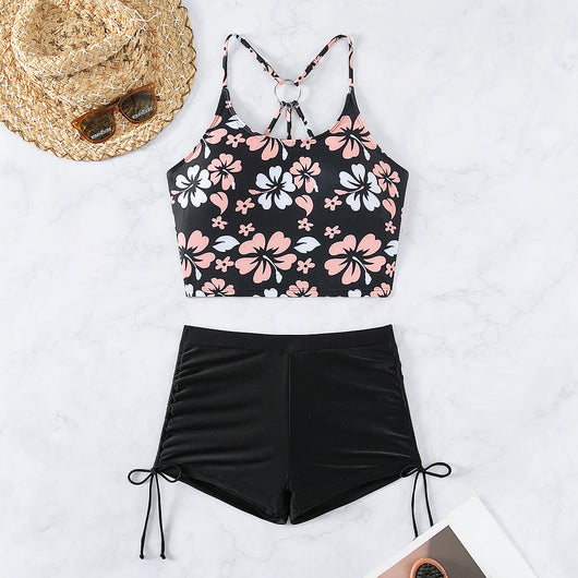 Women's two-piece swimsuit featuring a black halter crop top with pink and white floral print and solid black swim shorts. - Image 4