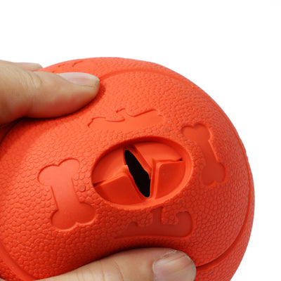 Red TPR dog leaking food ball with paw print patterns and a treat dispensing hole. - Image 3