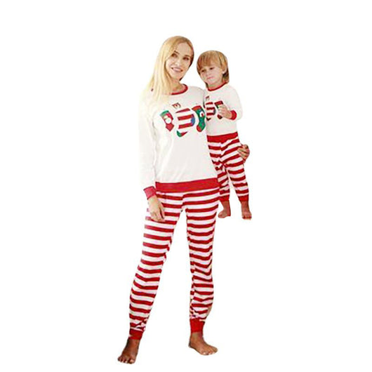 Father and son wearing matching Christmas pajamas with white long-sleeved tops featuring stocking prints and red and white striped pants. - Image 3