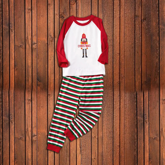 Matching family Christmas pajamas with white raglan tops, red sleeves, and a nutcracker graphic, paired with red, green, and white striped pants. Includes adult - Image 2