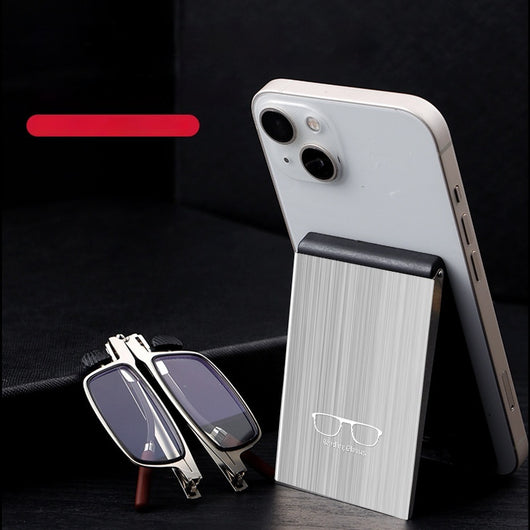 Foldable blue light blocking glasses with silver frames in a black case, shown on a smartphone.