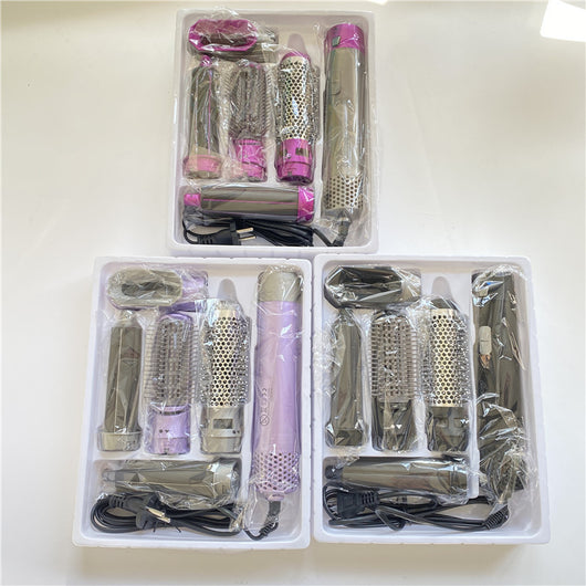 5-in-1 hot air comb hair dryer set with multiple rose red and gray attachments in a white tray. - Image 19