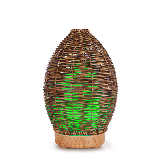 Hollow rattan aroma diffuser with an egg-shaped woven brown exterior and a light wood-grain base. - Image 2