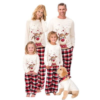 Family of four and a golden retriever wearing matching white long-sleeve reindeer tops and red plaid pajama pants. - Image 16
