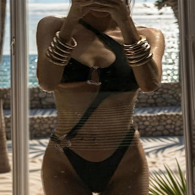 Black one-piece swimsuit with asymmetrical cutout design and gold-toned ring details, featuring a high-cut bottom. - Image 10